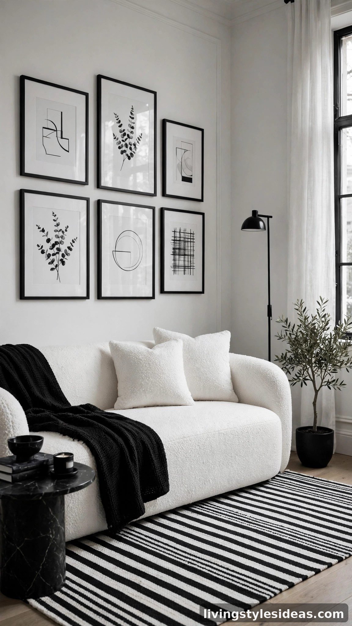 Chic black-and-white studio living corner with striped rug and framed art